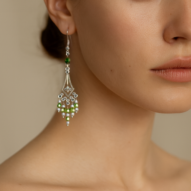 Green dangling silver earrings.