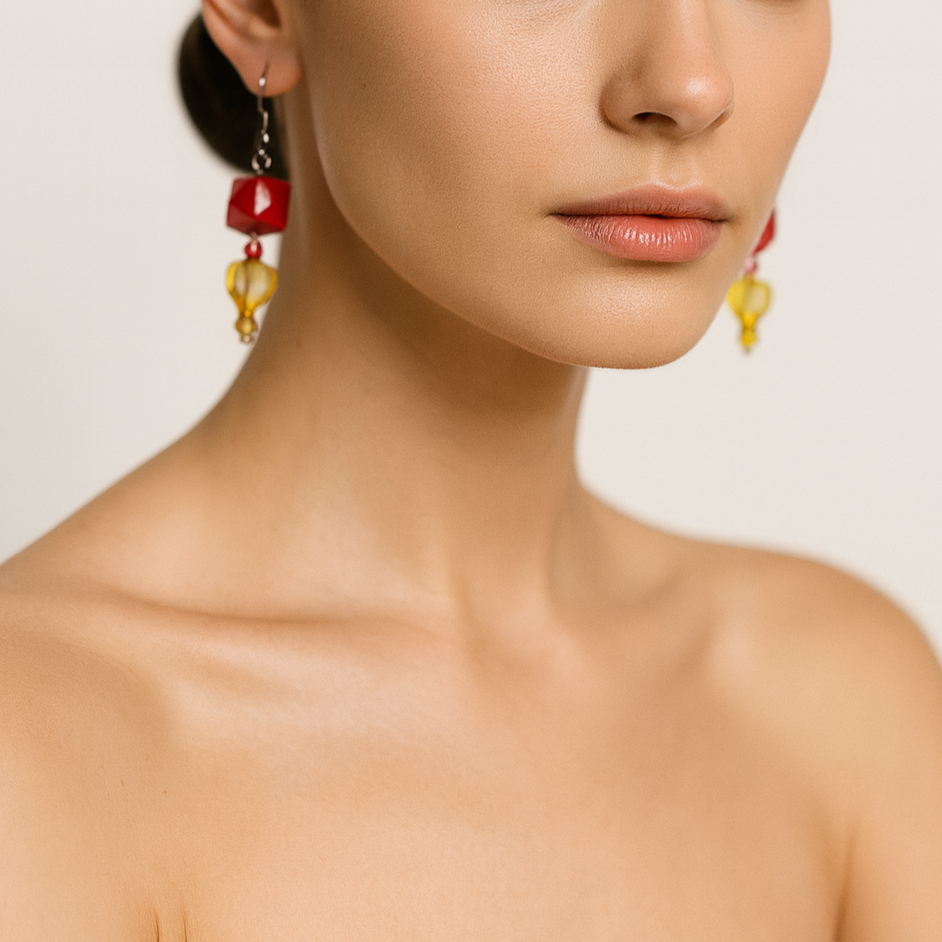 Dangling earrings with red and yellow beads.