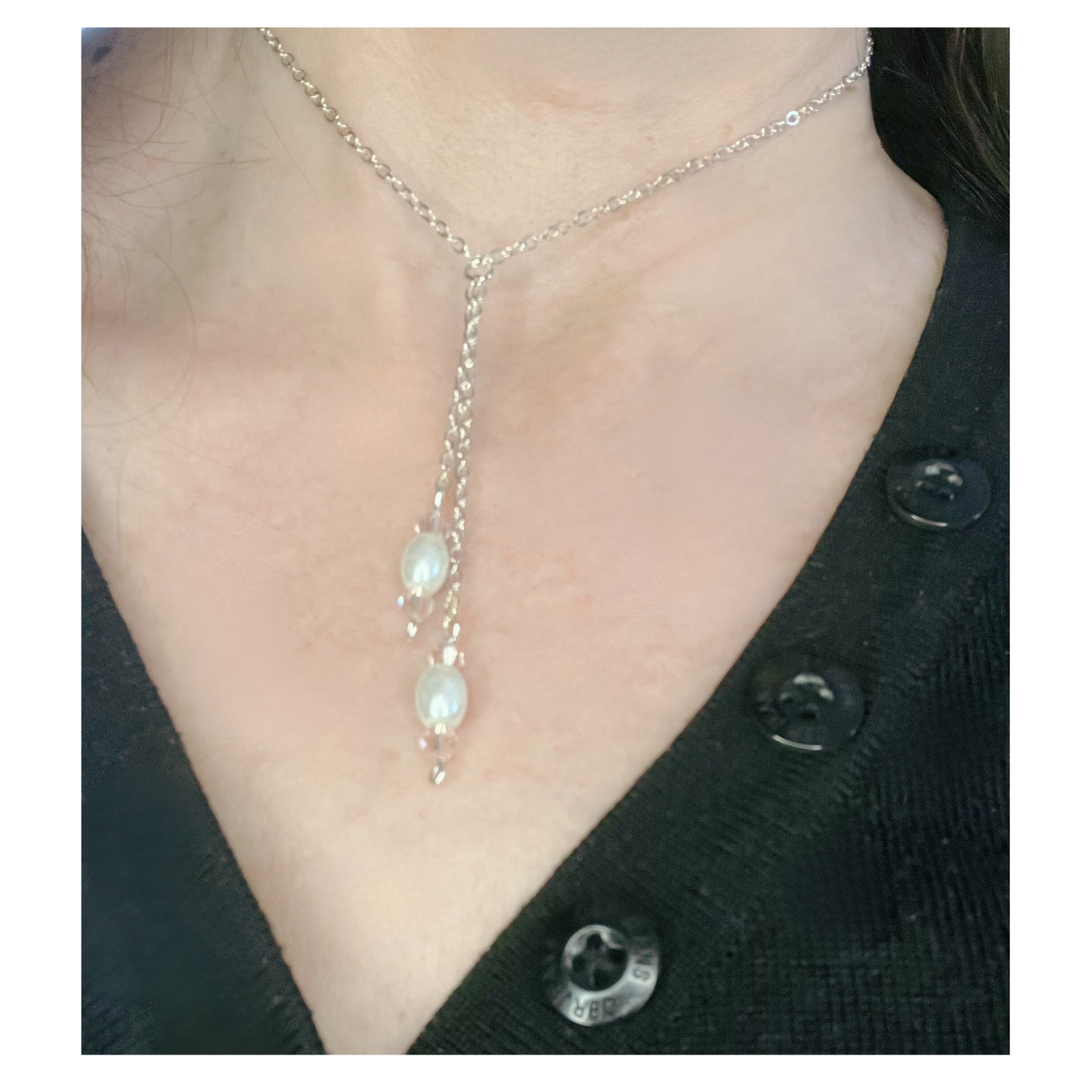 Silver necklace with pearl beads.