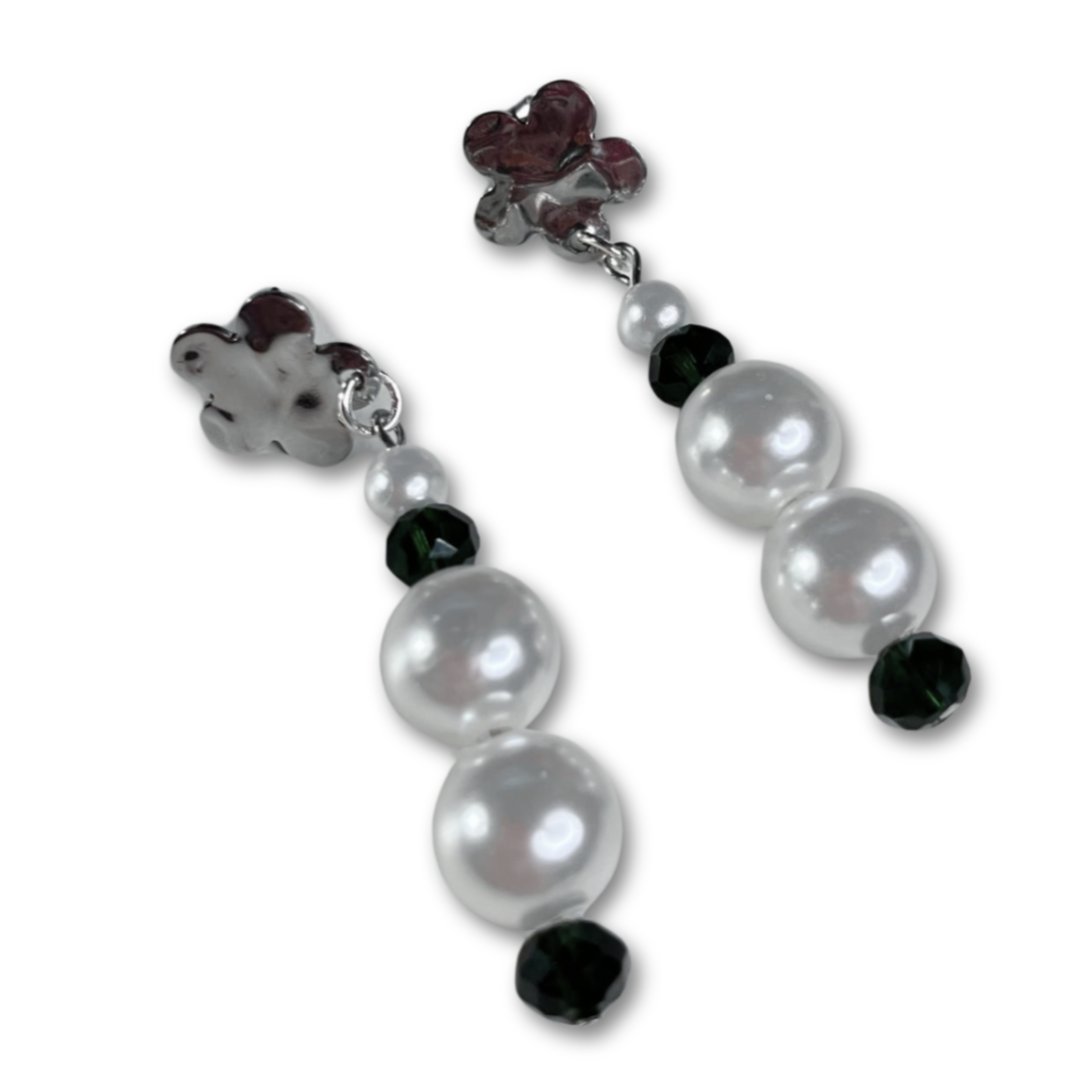 White imitation pearl earrings with green beads.