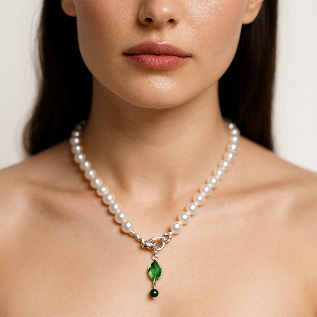 Pearl necklace with a green pendant.