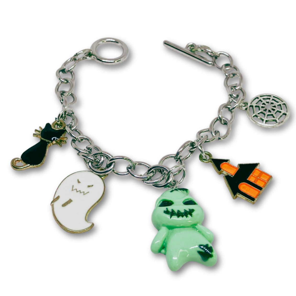 Bracelet with Halloween-themed charms including a ghost, jack-o'-lantern, and black cat on a white.