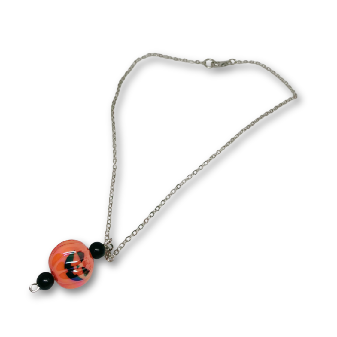 Silver necklace with a pumpkin-shaped pendant.