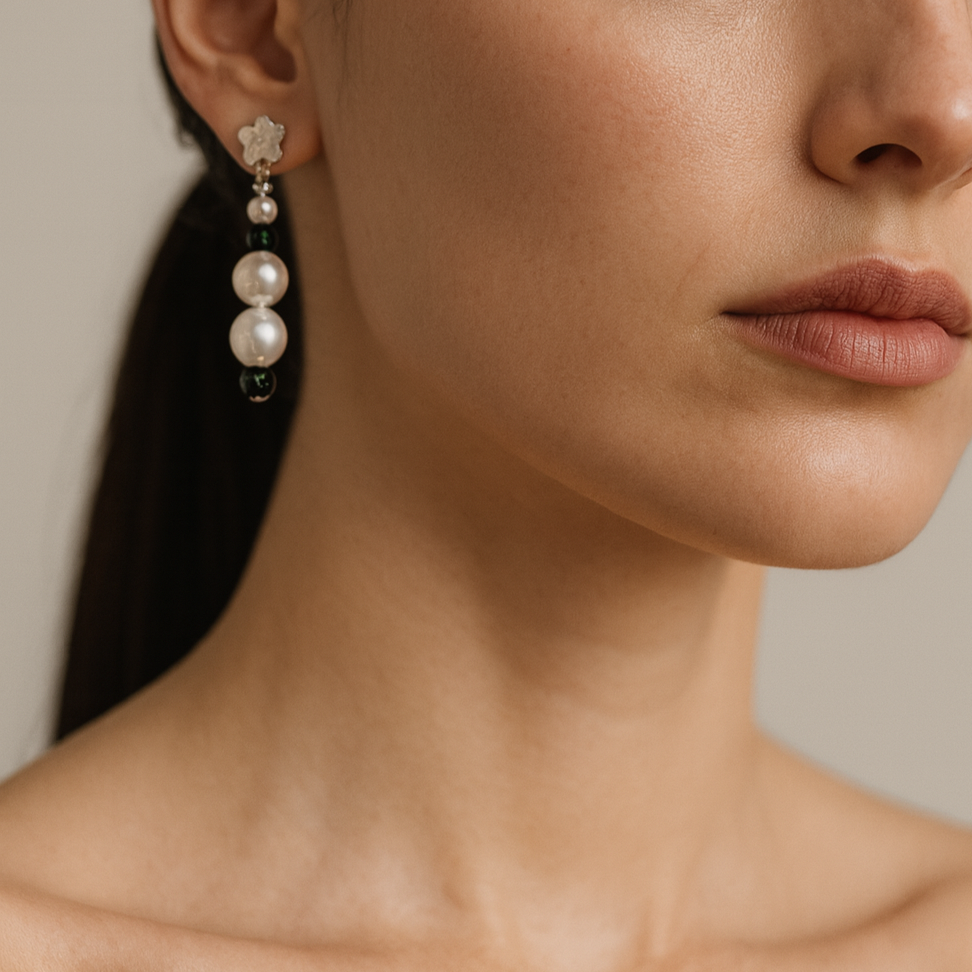 Pearl earrings with small dark green beads.