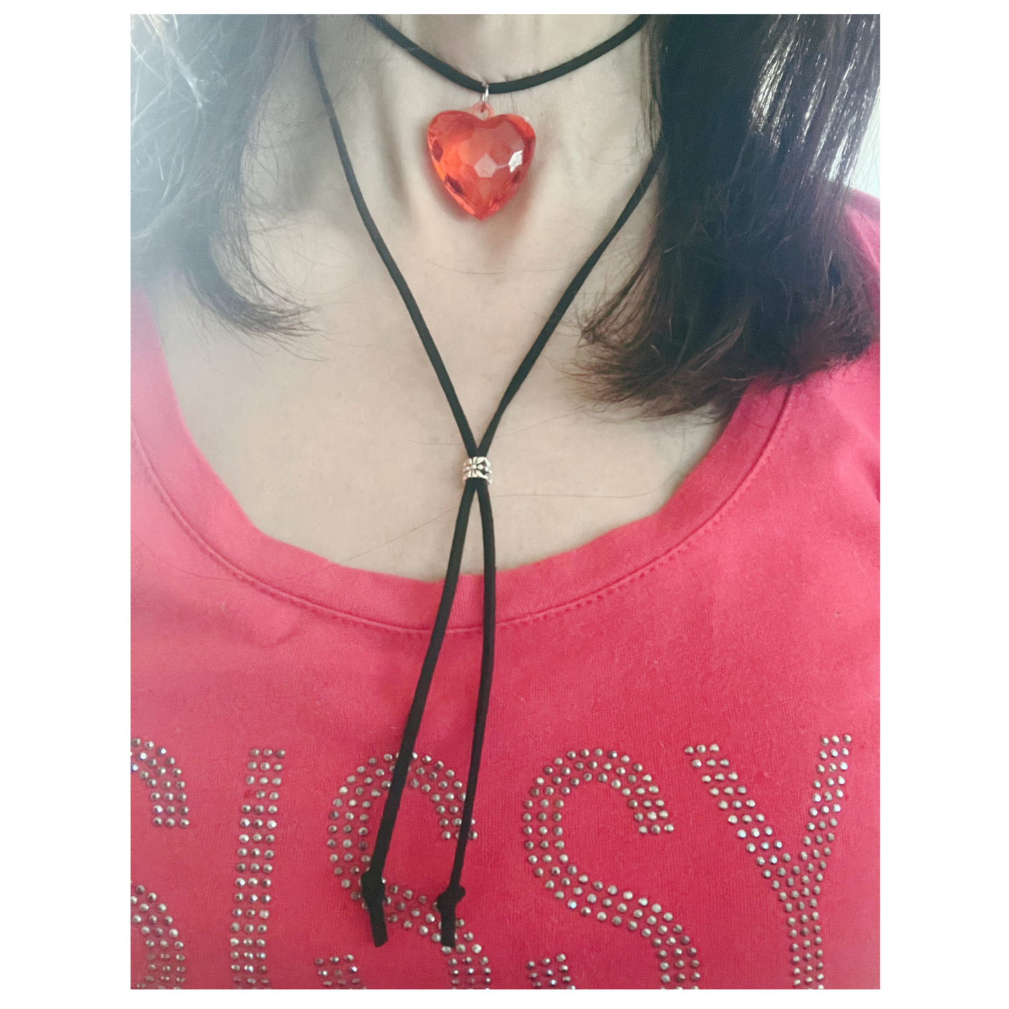 A layered black suede cord choker with a statement red heart pendant