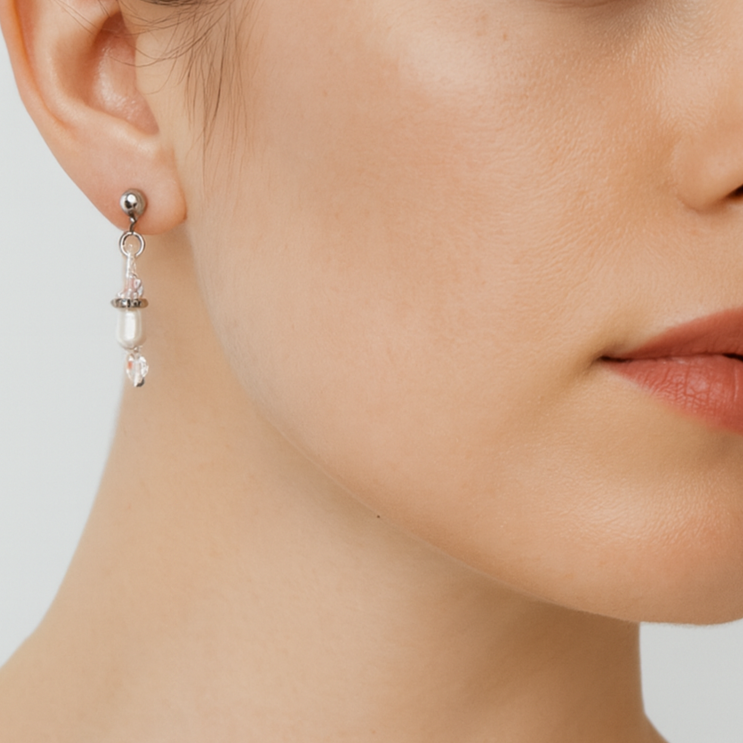 Silver earring with pink beads.
