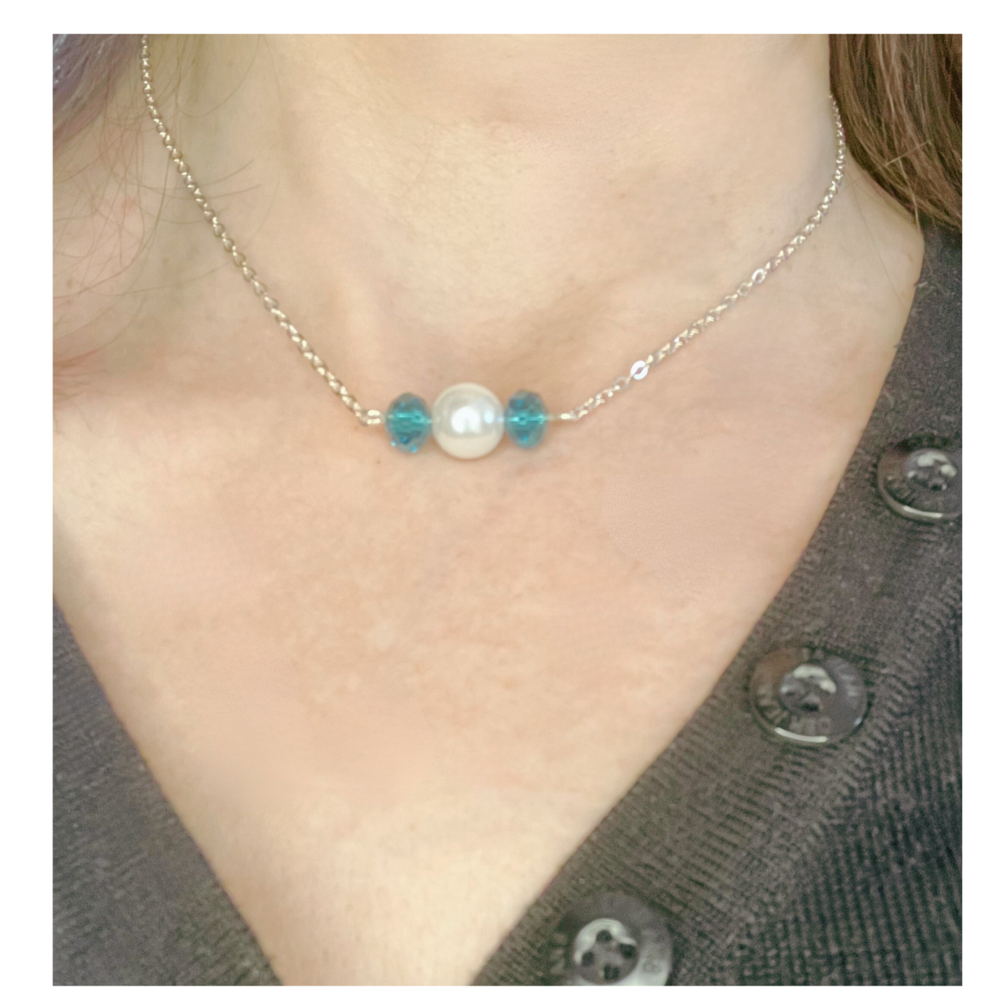 Silver necklace with blue and white beads.