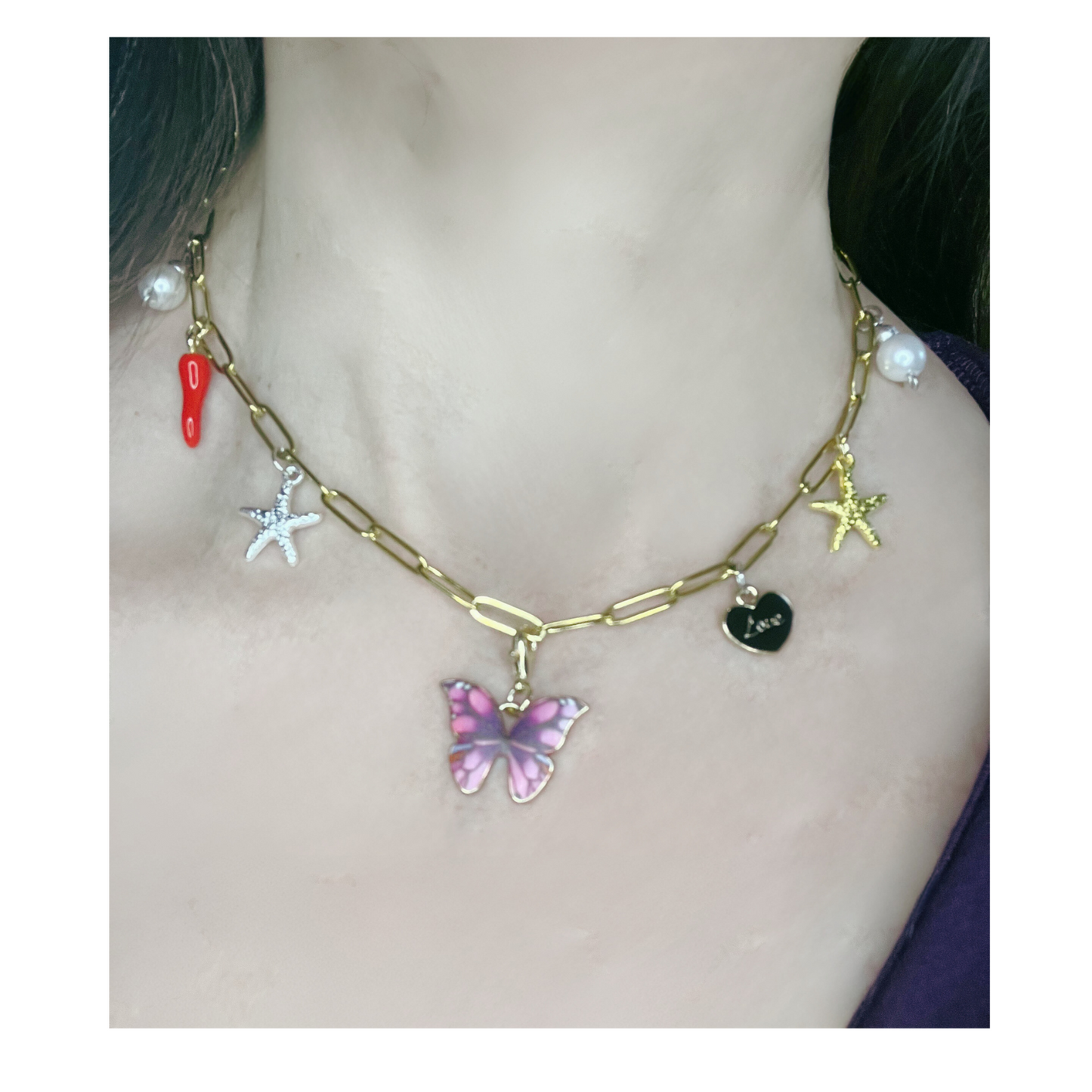 Imitation gold chain necklace with multiple charms (including a butterfly, chili, star, and pearl)