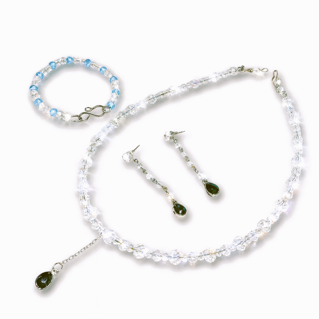 Jewelry set with necklace, bracelet, and earrings.