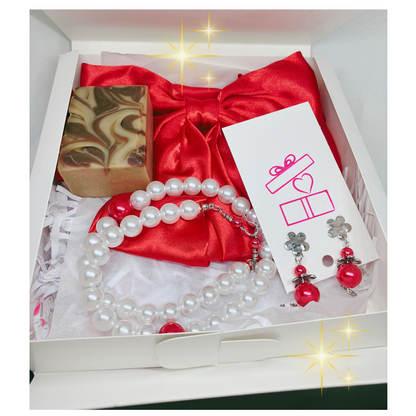 Gift set with red satin bow, pearl necklace, earrings, and soap in a box.