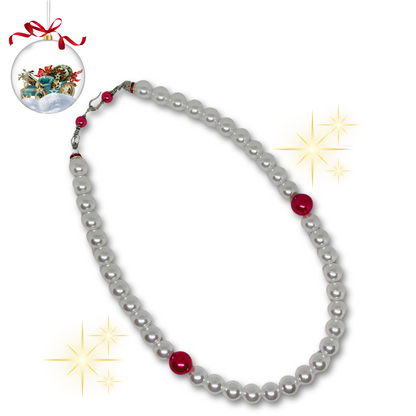 Pearl necklace with red beads.