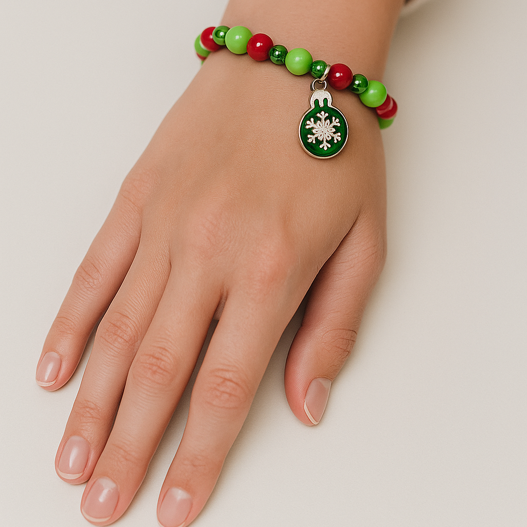 Red and green Christmas bracelet with snowflake charm.