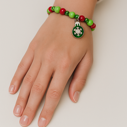 Red and green Christmas bracelet with snowflake charm.