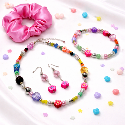 This set includes: Satin Pink Hair Scrunchie, Multi color Beaded Necklace, matching Bracelet and Dangling matching Earrings.