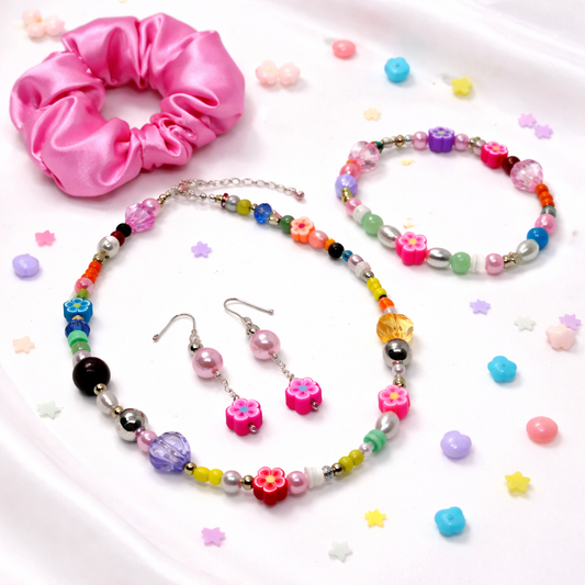 This set includes: Satin Pink Hair Scrunchie, Multi color Beaded Necklace, matching Bracelet and Dangling matching Earrings.
