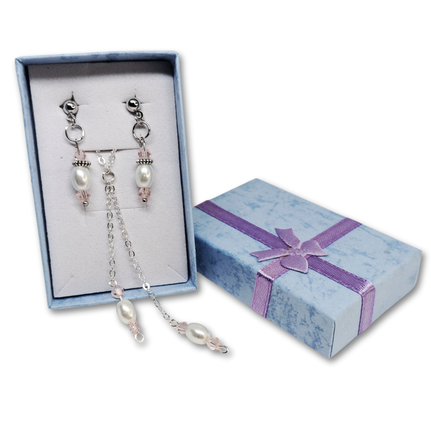 Gift set of silver necklace with matching earrings and blue gift box.