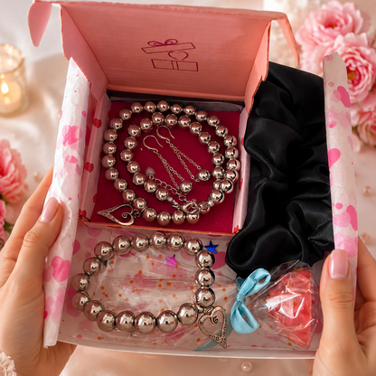 White gift box with jewelry, black hair scrunchie and free gift