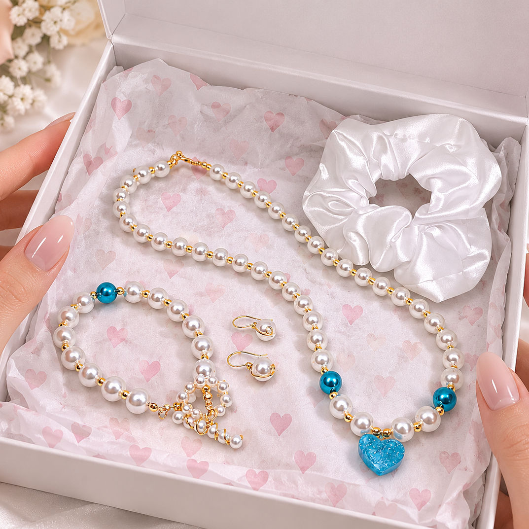 Jewelry set with pearl necklace, bracelet, earrings, and scrunchie in a gift box.