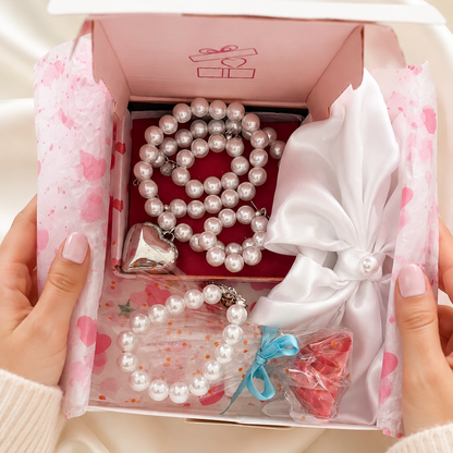 White gift box with jewelry and white satin hair bow and free gift.