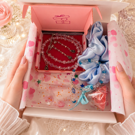 Set of jewelry including a necklace and earrings a blue scrunchie.