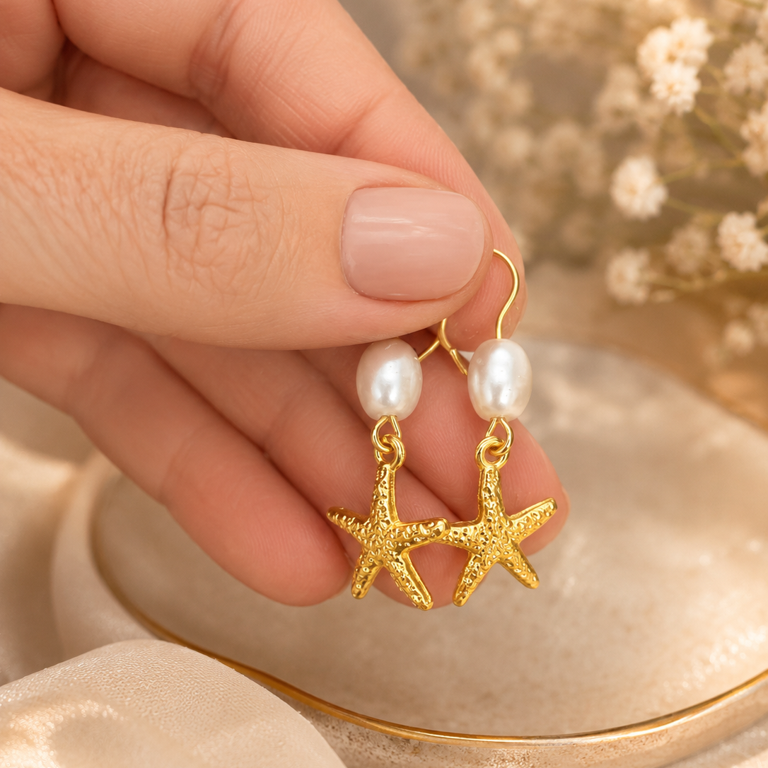 Gold starfish earrings with pearls.