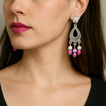 Silver earrings with pink beads.