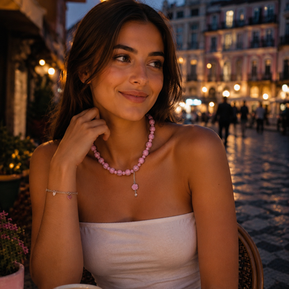 pink beaded necklace with a rose pendant.