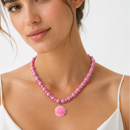 pink beaded necklace with a rose pendant.