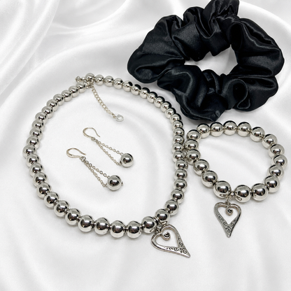 Chic Silver set for women featuring silver pearls necklace, matching bracelet, earrings and black satin hair scrunchie.