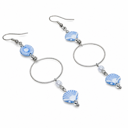 Pair of earrings with blue and white shell-like beads.