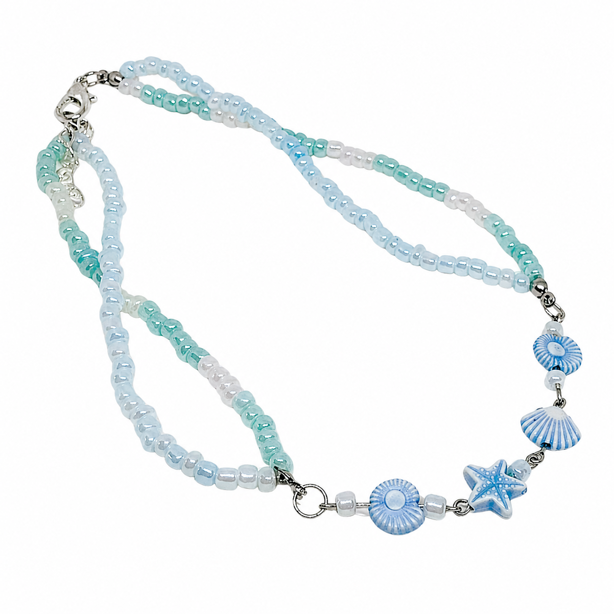 Necklace with blue and white beads and sea shell beads.