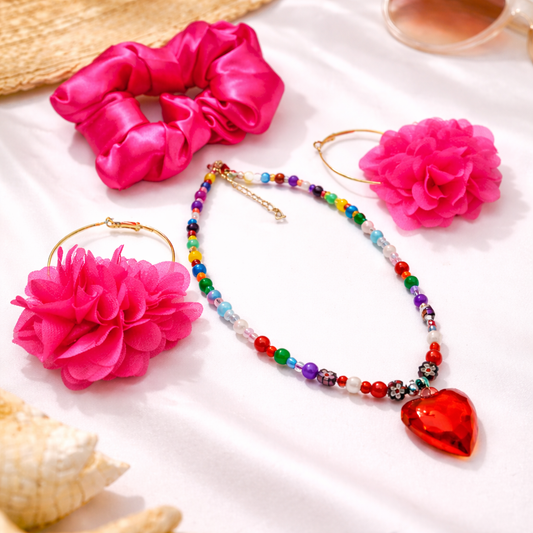 Gift Set consisting of  pink satin scrunchie, colorful beaded necklace with heart pendant, and pink floral earrings.