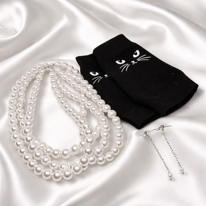 Gift set consisting of four strand pearl choker, dangling earrings and fingerless black cat gloves.