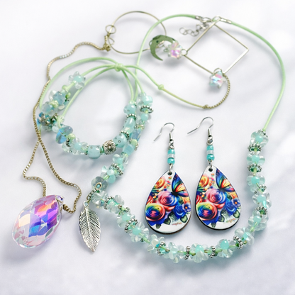 Gift set includes, green rope necklace with turquoise beads and leaf pendant, matching bracelet, dangling flower earrings and gold sun catcher with glass diamond.