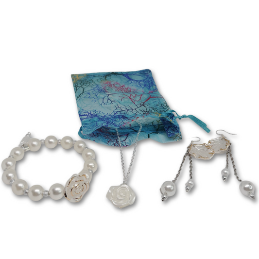 Gift set includes, silver necklace with rose pendant, matching pearl bracelet with rose and matching dangling earrings. 
