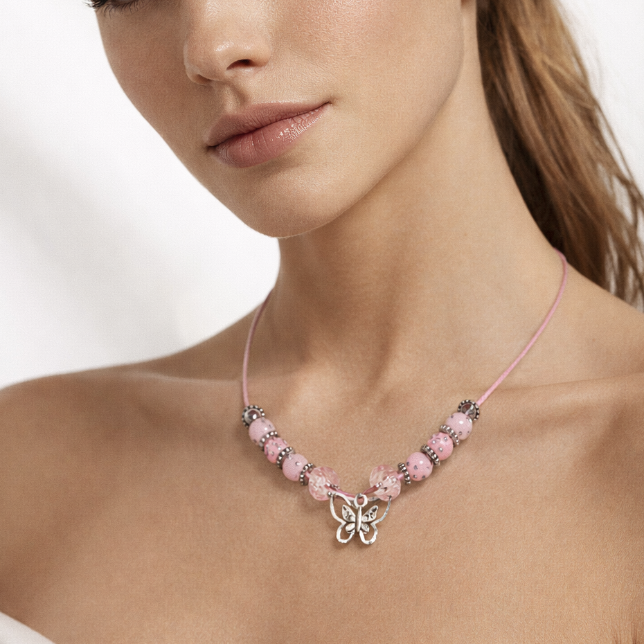 Pink cord necklace with pink beads and butterfly pendant.