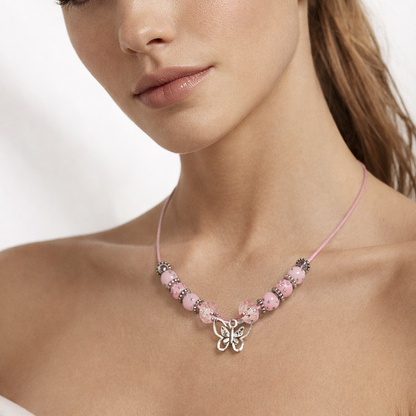 Pink cord necklace with pink beads and butterfly pendant.