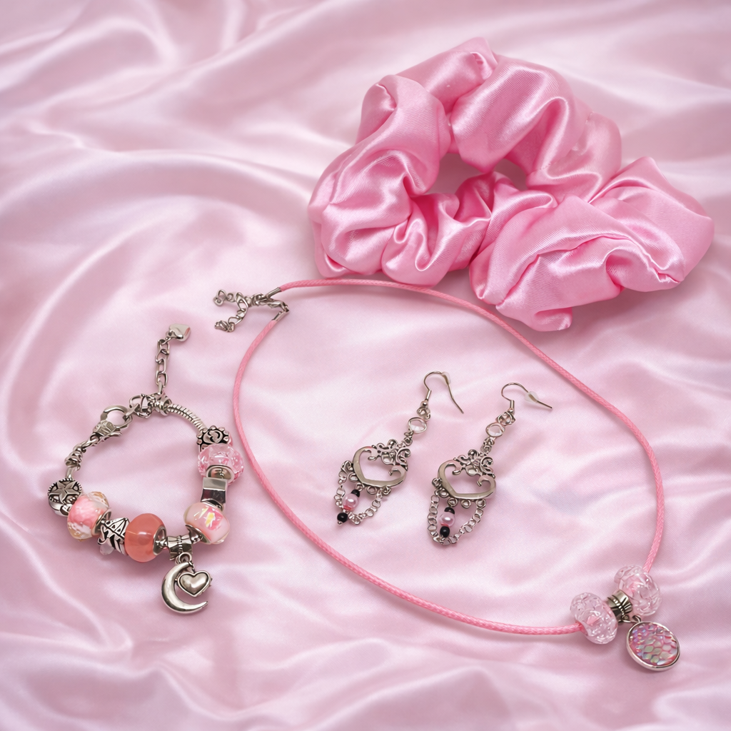 Gift set includes, pink satin scrunchie, dangling silver earrings, necklace and charm bracelet, packed in gift box.