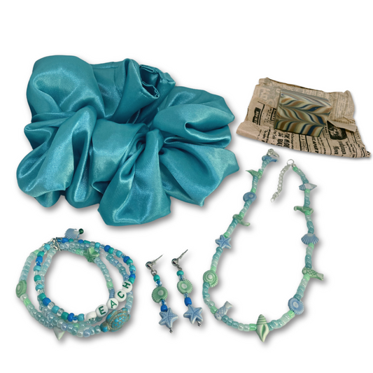 This gift set includes, turquoise satin hair scrunchie, three beach themed bracelets, matching necklace, earrings and mini soap forest fragrance. 