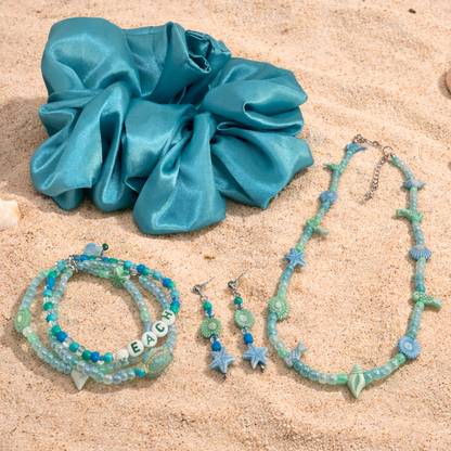This gift set includes, turquoise satin hair scrunchie, three beach themed bracelets, matching necklace, earrings.