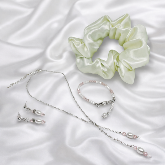 This gift set for women featuring silver necklace with white imitation pearl and pink glass beads with matching earrings, bracelet and satin scrunchie.