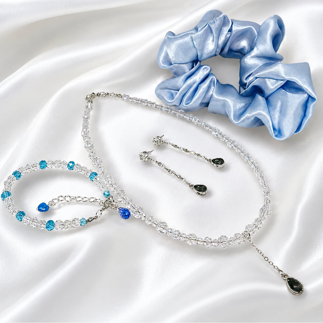 This set includes, necklace with glass beads, matching bracelet, earrings and satin hair scrunchie.