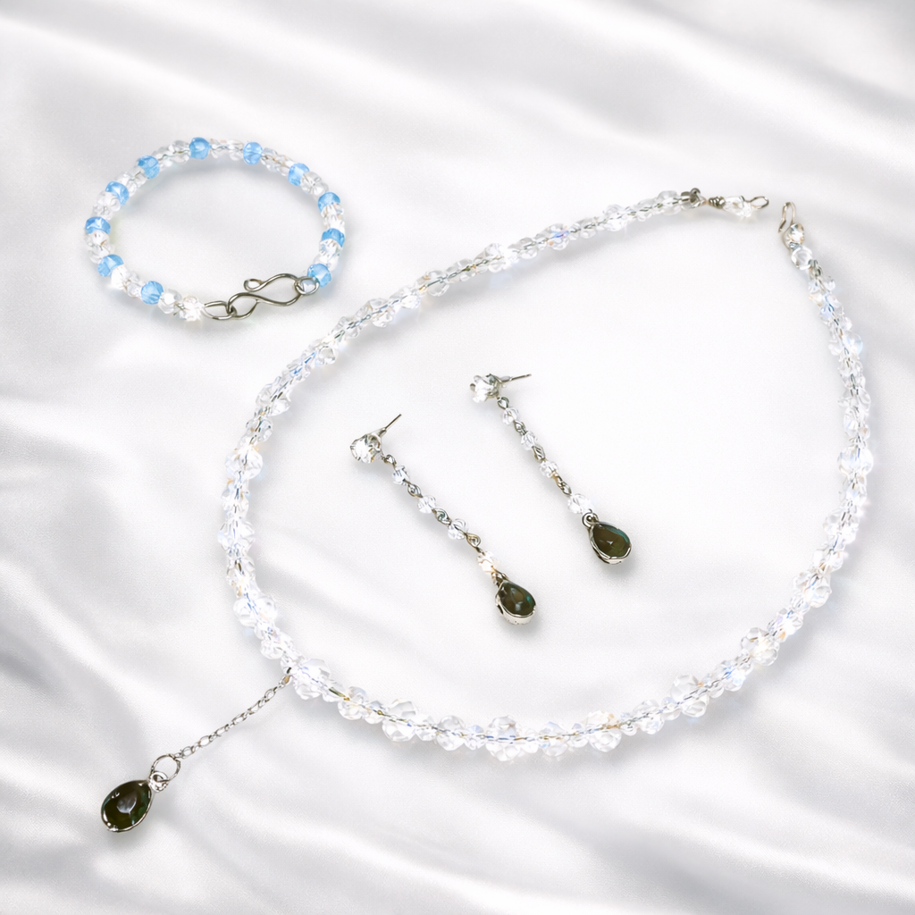 Jewelry set with necklace, bracelet, and earrings.