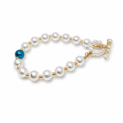 Pearl bracelet with gold accents and a blue bead 