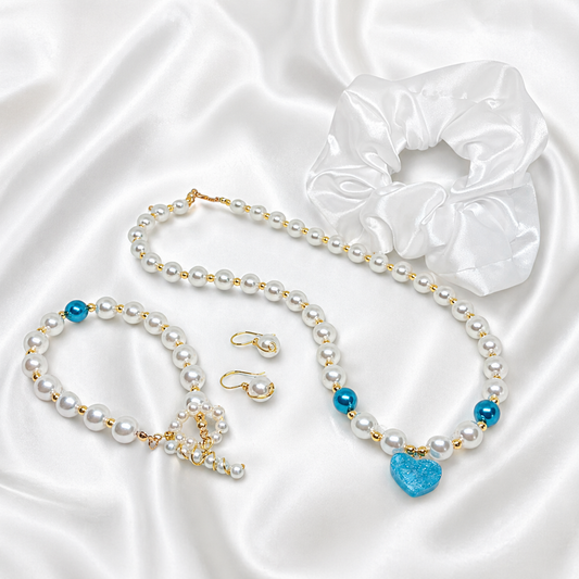 Pearl necklace with blue resin heart charm, matching bracelet, earrings and white satin hair scrunchie.