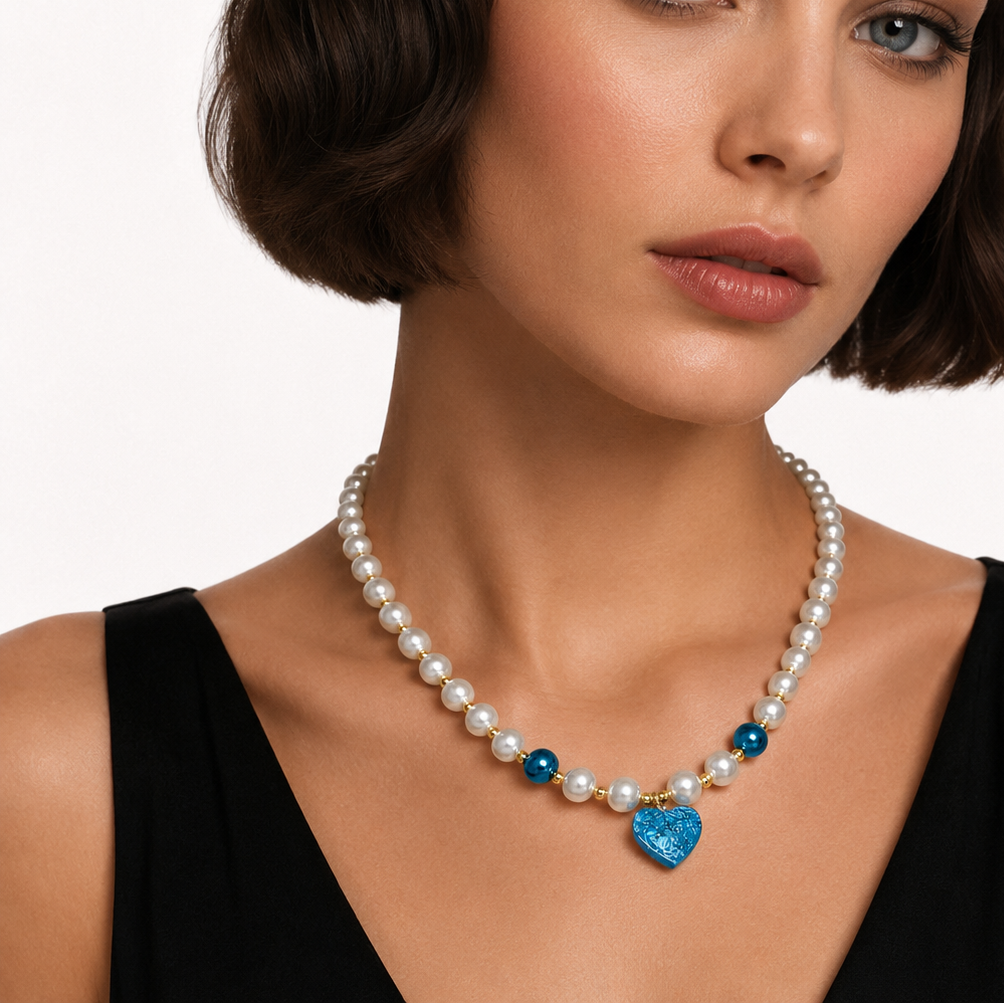 Pearl necklace with blue heart.