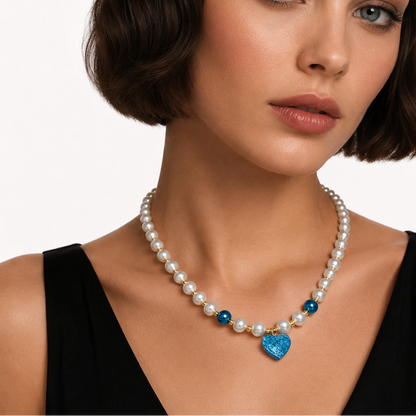 Pearl necklace with blue heart.