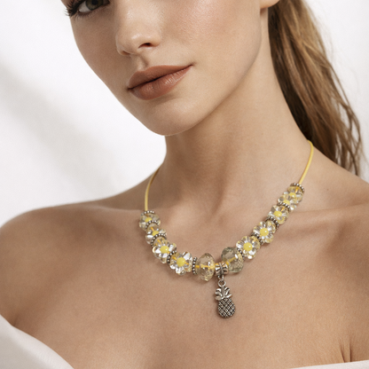 Yellow rope necklace with glass beads and pineapple pendant.