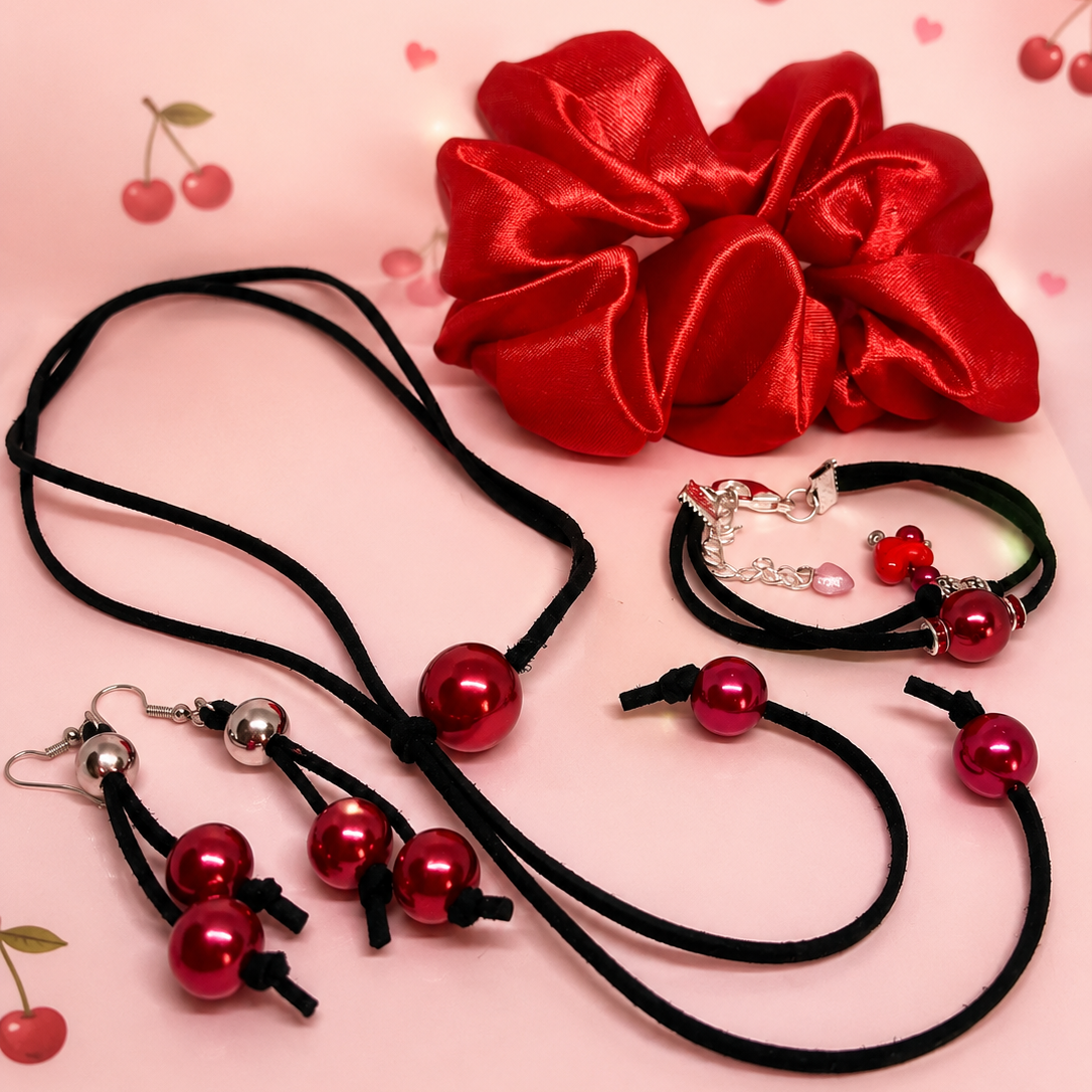 Serene Glow gift set for women, feature red satin scrunchie for hair, black suede cord with red beads, matching dangling earrings.
Packed in gift box.