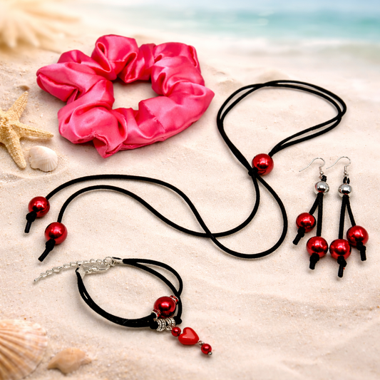 Serene Glow gift set for women, feature red satin scrunchie for hair, black suede cord with red beads, matching dangling earrings.
Packed in gift box.